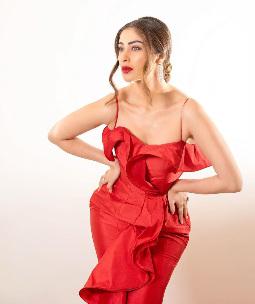 actress Raai Laxmi wearing a red evening dress posing in a studio